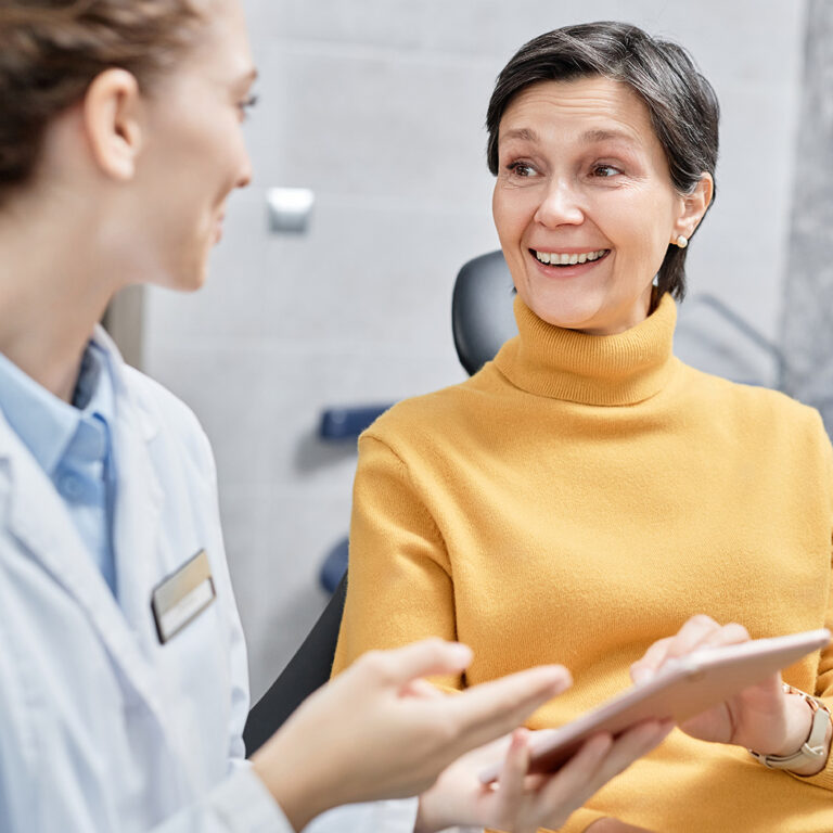 a patient talks to her oral surgeon